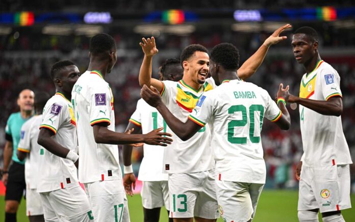 Bamba Dieng of Senegal celebrates with teammates after the 3-1 win during the FIFA World Cup Qatar 2022 Group A match between Qatar and Senegal at Al Thumama Stadium on November 25, 2022 in Doha, Qatar. (Photo by Stuart Franklin/Getty Images)